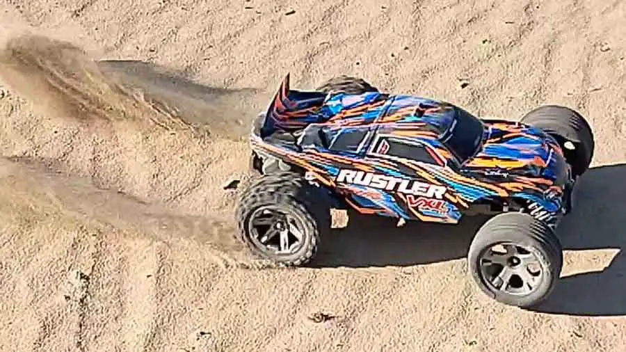 Traxxas Rustler standing start in sand